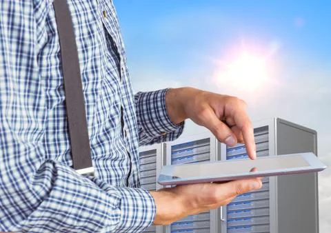 Man using digital tablet against office building in background Fotos de archivo