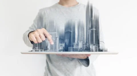 A man using digital tablet, and modern buildings hologram Stock Photos