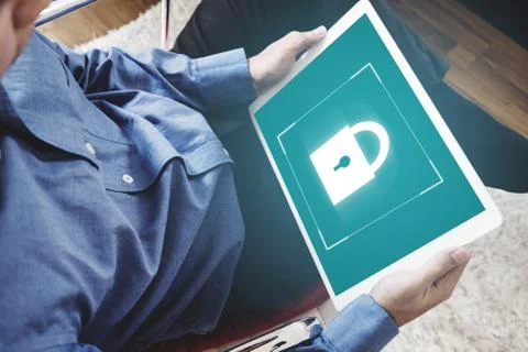 A man using digital tablet and lock icon on screen Stock Photos