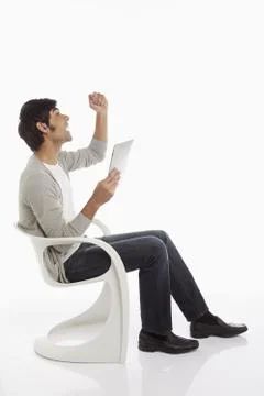 Man using a digital tablet, cheering Stock Photos