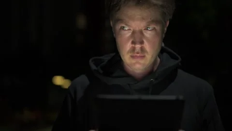 Man using digital tablet computer outdoors at night Stock Footage 317369163