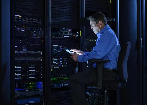 Man using digital tablet in data center Stock Photos