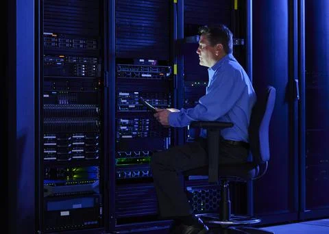 Man using digital tablet in data center Stock Photos