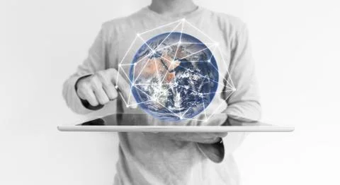 A man using digital tablet. Element of this image are furnished by NASA Stock Photos