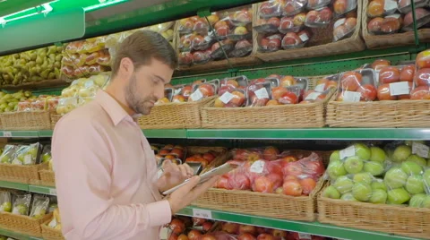 Man using digital tablet at fruit counter In supermarket Stock Footage 63370487