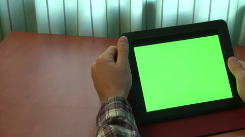 Man using digital tablet with a green screen Stock Footage 32879232