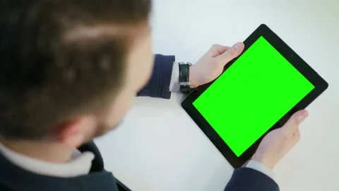 A Man Using an Digital Tablet with a Green Screen Stock Footage 84768111
