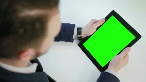 A Man Using an Digital Tablet with a Green Screen Stock Footage 84768256