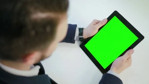 A Man Using an Digital Tablet with a Green Screen Stock Footage 84768472