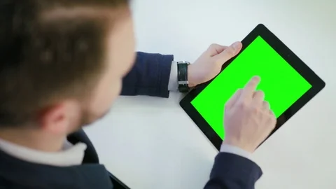A Man Using an Digital Tablet with a Green Screen Stock Footage 84768602