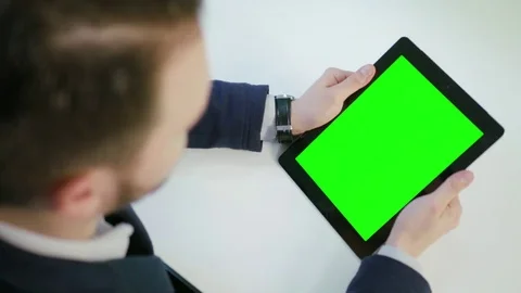 A Man Using an Digital Tablet with a Green Screen Stock Footage 84768658