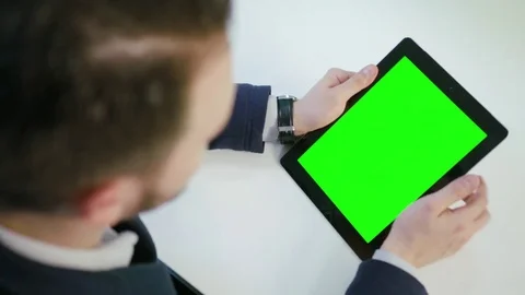 A Man Using an Digital Tablet with a Green Screen Stock Footage 84769047
