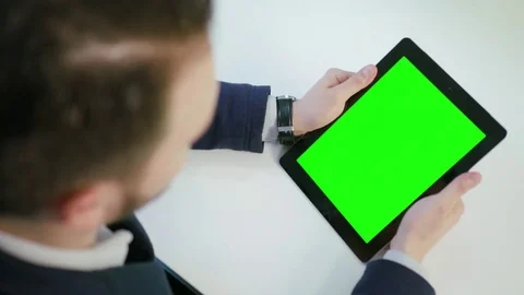 A Man Using an Digital Tablet with a Green Screen Stock Footage 84769055