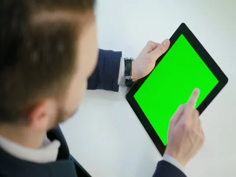 A Man Using an Digital Tablet with a Green Screen Stock Footage 84769284