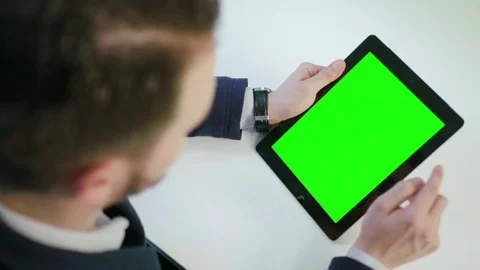 A Man Using an Digital Tablet with a Green Screen Stock Footage 84769467