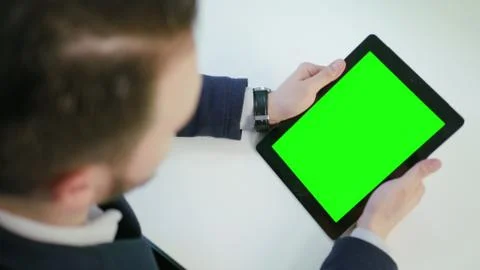 A Man Using an Digital Tablet with a Green Screen Stock Photos