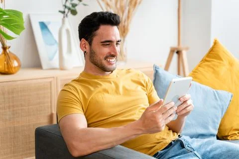 Man using digital tablet at home. Stock Photos