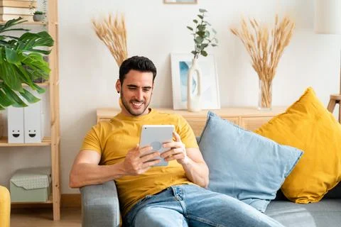 Man using digital tablet at home. Stock Photos
