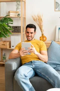 Man using digital tablet at home. Stock Photos