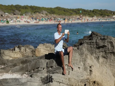Man Using Digital Tablet Inspect Beach Wireless Connection People Play Swimming Stock Footage 77037009