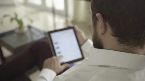 Man using digital tablet, over the shoulder view Video stock 75188145
