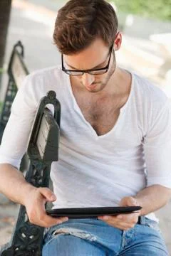 Man using a digital tablet, Paris, Ile-de-France, France Stock Photos