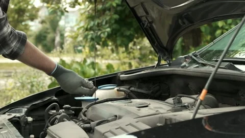 Man using dipstick to check the oil level in a car engine Stock Footage 242419648