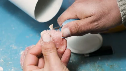 Man using a Drill on a Dental Prosthesis Stock Footage 146290489