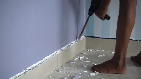 Man using drill machine to hacking remove tiles from wall. Stock Footage 100314342