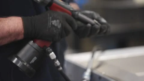 A man is using a drill to make a hole in a metal surface Video stock 302456928