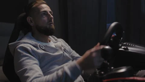 A man using a driving simulator Stock-Footage 258391302