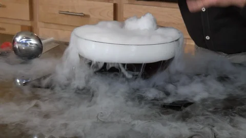 Man using dry ice during experiment Stock Footage 99047756
