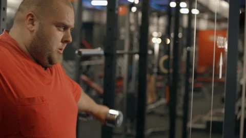 Man using dumbbell in hands and workout in gym Stock Footage 109058240