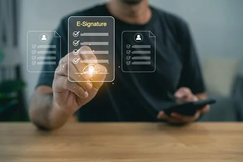 Man using e-signature on digital tablet for electronic document signing. Vi.. Stock Photos