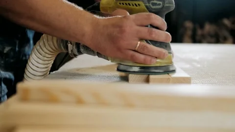 A man Using Electric Sander for wood in a carpentry workshop. Carpentry. Stock Footage 140277217