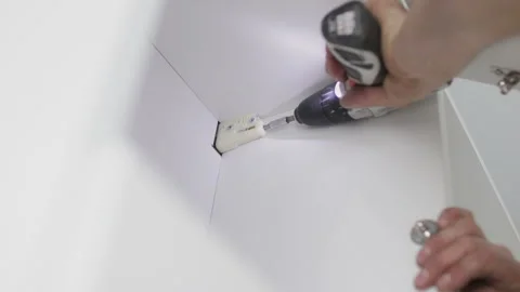 Man using electric screwdriver to tighten screw Stock Footage 106525579