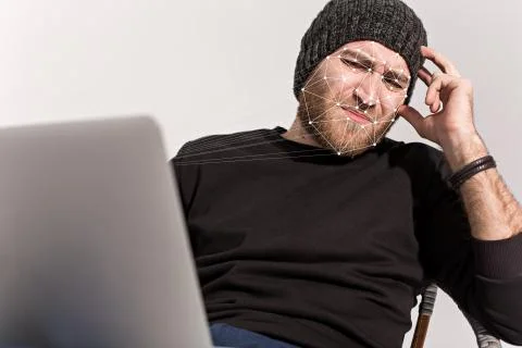 Man using face ID on a laptop recognition system Stock Photos