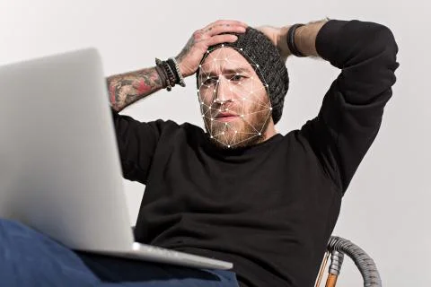 Man using face ID on a laptop recognition system Stock Photos