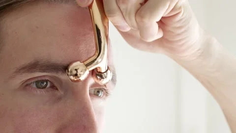 Man using face roller Stock Footage 222794977