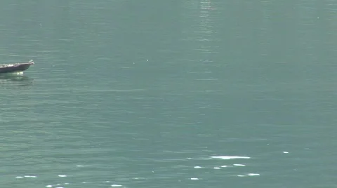 Man using feet to row boat Stock Footage 290213