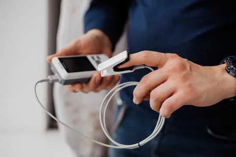 Man using finger pulse oximeter, healthcare monitoring concept. Pulse oximeter Stock Photos