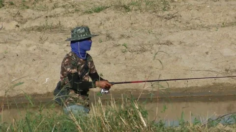 Man using fishing rod to catch fish in the pool Stock Footage 69168671