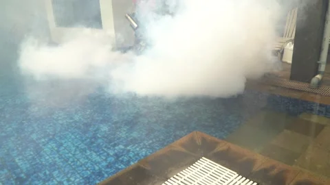 Man using fogging machine and spraying chemical to prevent dengue fever Stock Footage 159393854