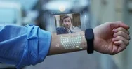 A Man Using Futuristic Holographic Phone In His Arm For Call His Friend  Stock Footage
