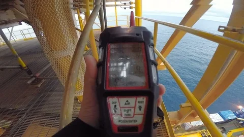 Man using gas detector or instrument in processing platform or plant Stock Footage 113942568