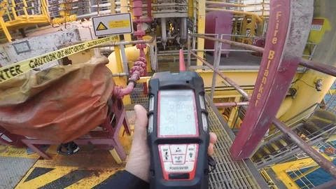 Man using gas detector or instrument in processing platform or plant Stock Footage 113943662
