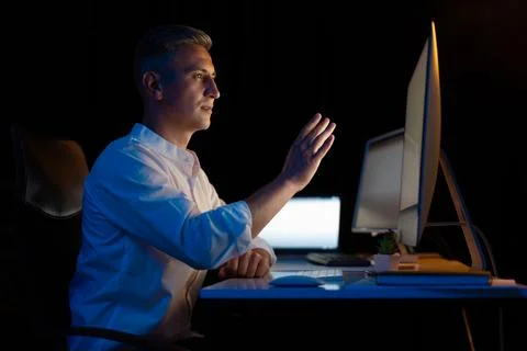 Man Using Gesture Control Interface in Modern Office at Night Stock Photos