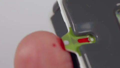 Man using a glucometer after pricking his finger for blood Stock Footage 166215513