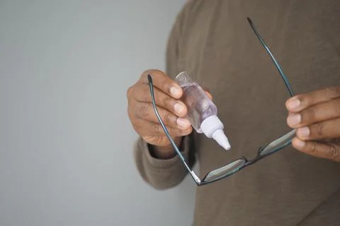 A man using glue to fix the broken eye glass Stock Photos