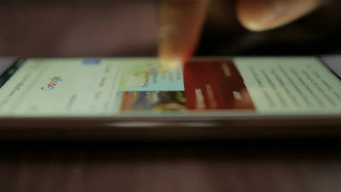 Man Using Google search engine to find informations on the Internet. Close-up Stock Footage 86464764